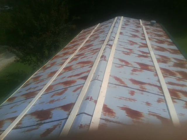 Rusted metal roof panels with new wood purlins before replacement — Storm Damage Roof Repair in Mc Connells by Roofing Brothers