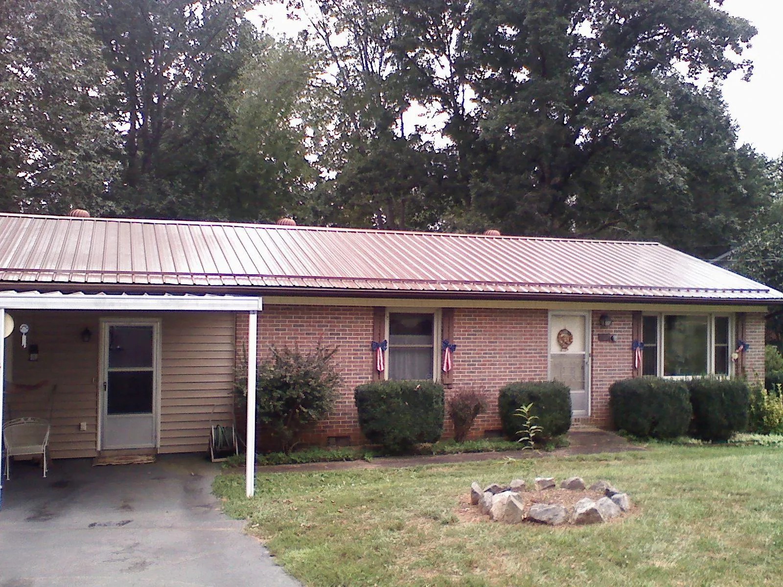 Bronze metal roof and carport on a brick ranch home — Roof Repair work by our crew in Mc Connells